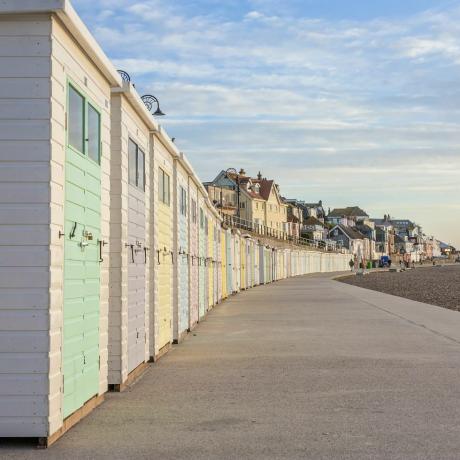 pastelowe kolorowe chaty plażowe wzdłuż promenady w lyme regis, dorset