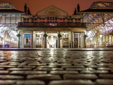 Covent Garden Piazza nocą ze światłami odbijającymi się w bruku